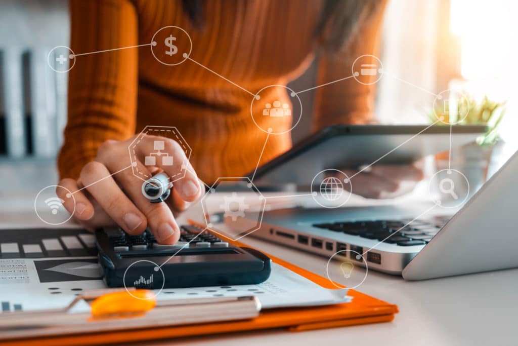 A Self-Directed IRA account holder calculating her earnings or losses applicable to the excess IRA contribution. Icons of dollar sign, individuals, graphs, magnifying glass are in front.