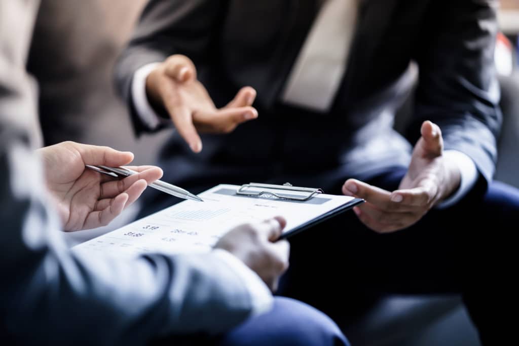 Business,partners,discussing,documents,and,ideas,at,meeting